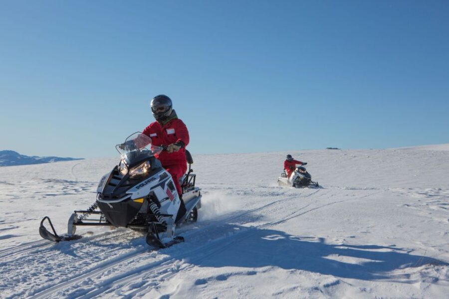Queenstown: Snowmobiling Experience with Helicopter Flight - Snowmobiling on the Garvie Mountain Range: pace, controls, and photo stops