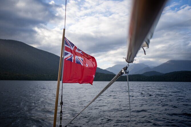 Scenic Cruise & Guided walk on Historic Motor Yacht Lake Te Anau - The cruise rhythm: safety briefing, tea time, and sails above you